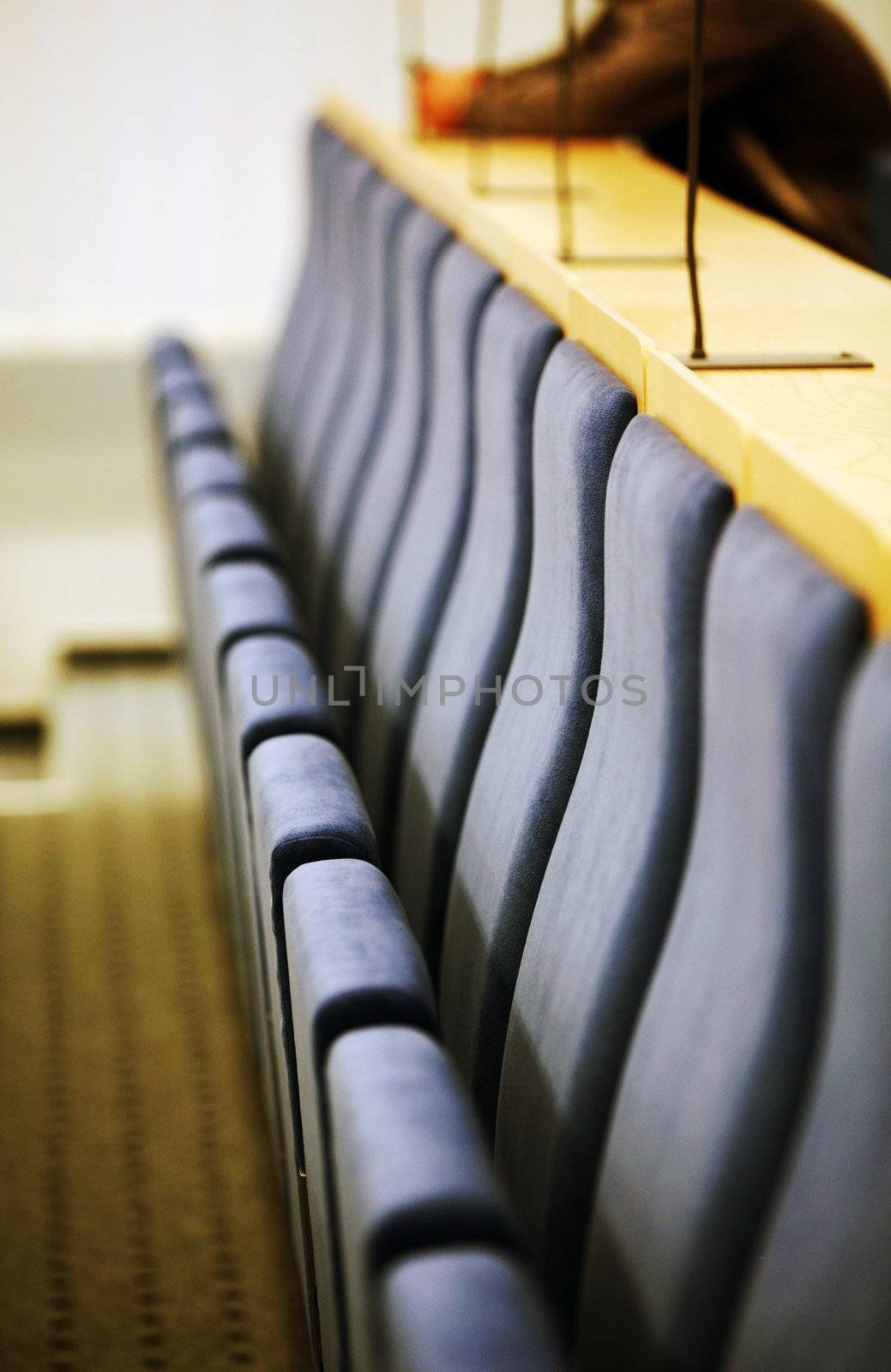 Detail of interior of court room with seats and microphones