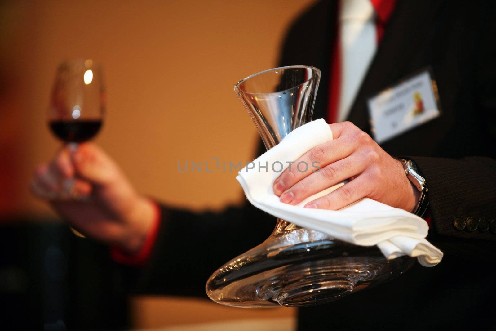 Degustator with carafe and red wine in glass