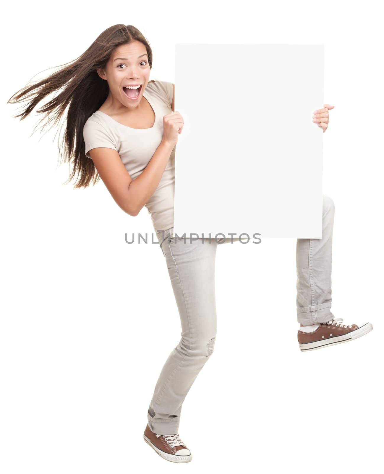 Banner ad woman holding a blank white poster billboard - excited and dynamic. Multiracial female model isolated standing on white background.