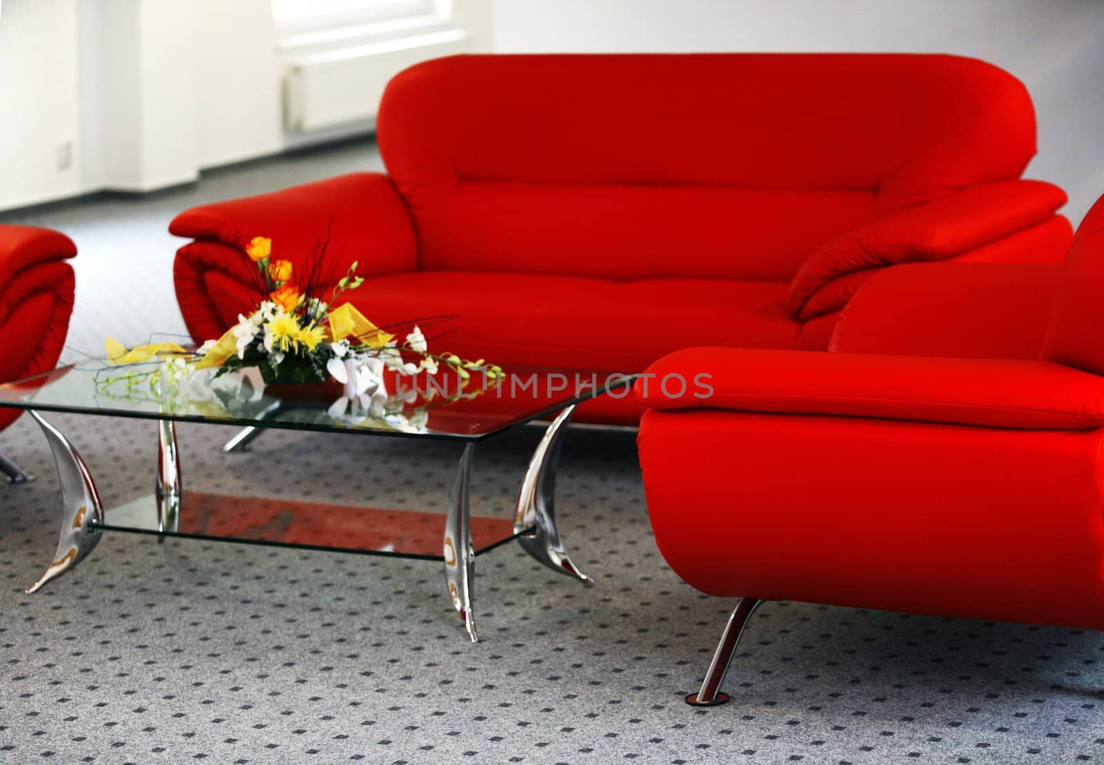 Interior with red sofa and glass table