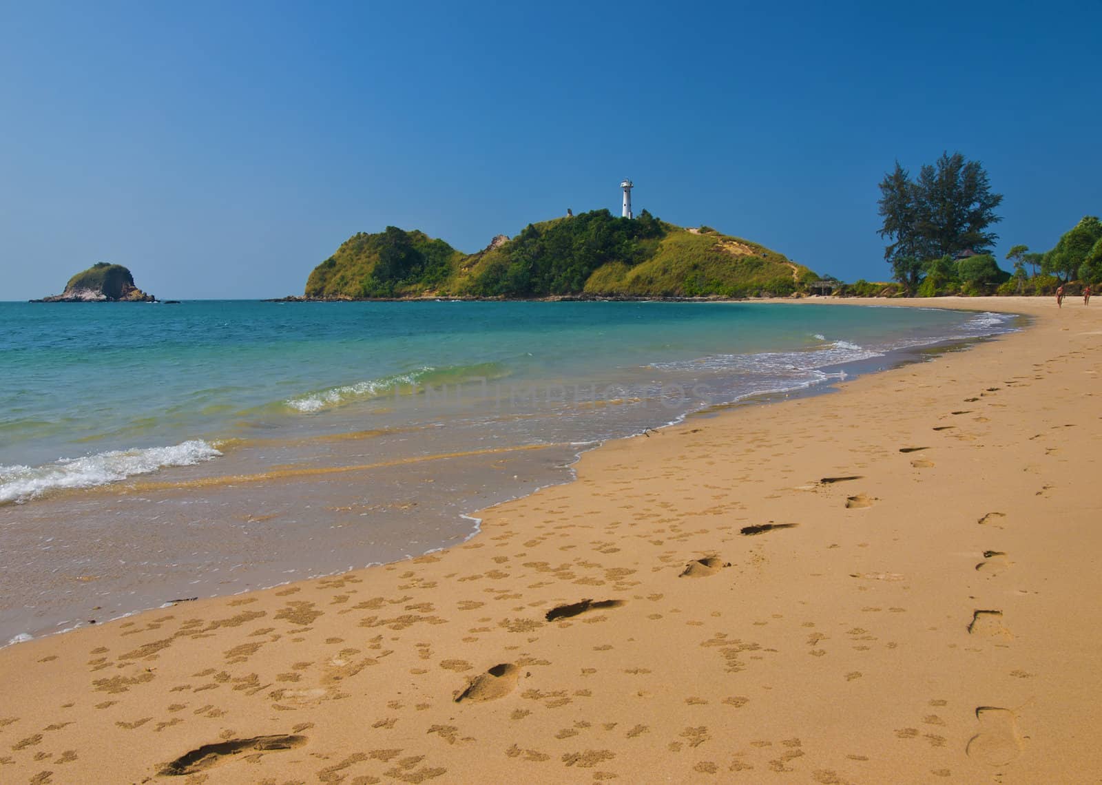 Couple walking around a tropical beach.