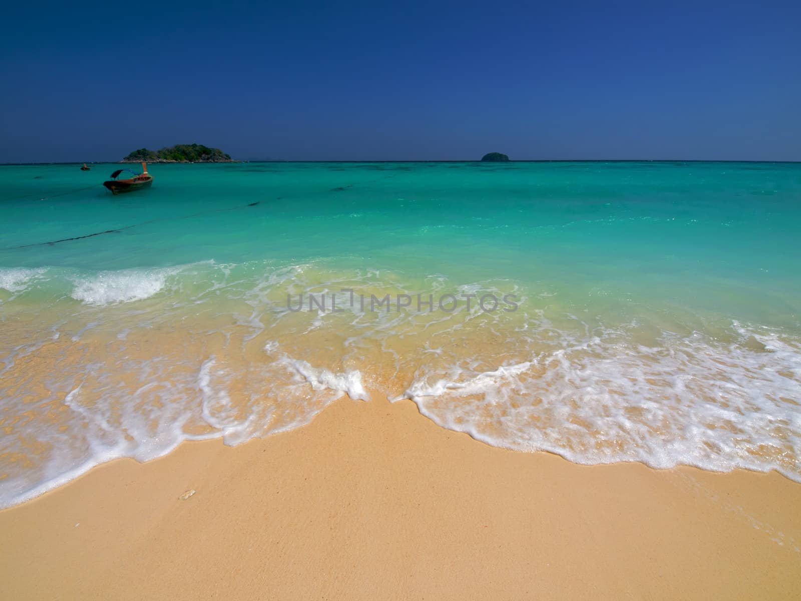 Turquoise sea and yellow sand on a tropical beach
