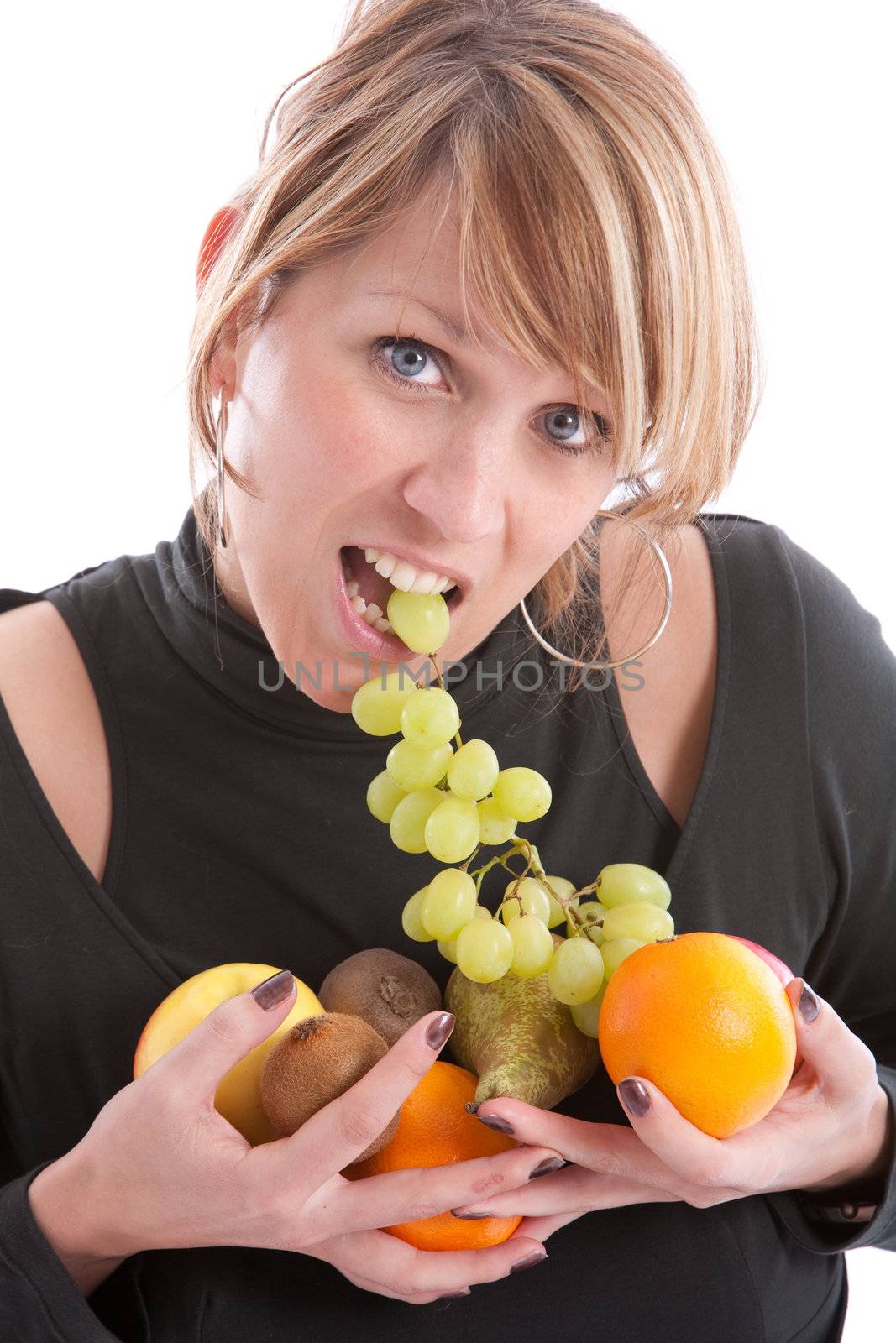 Pretty young blond girl with her teeth in a bunch of grapes