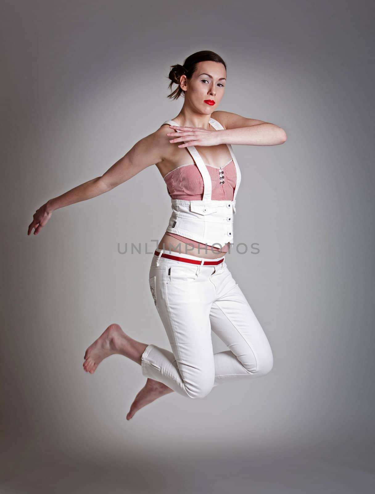 Beautiful woman in fashionable clothes jumping
