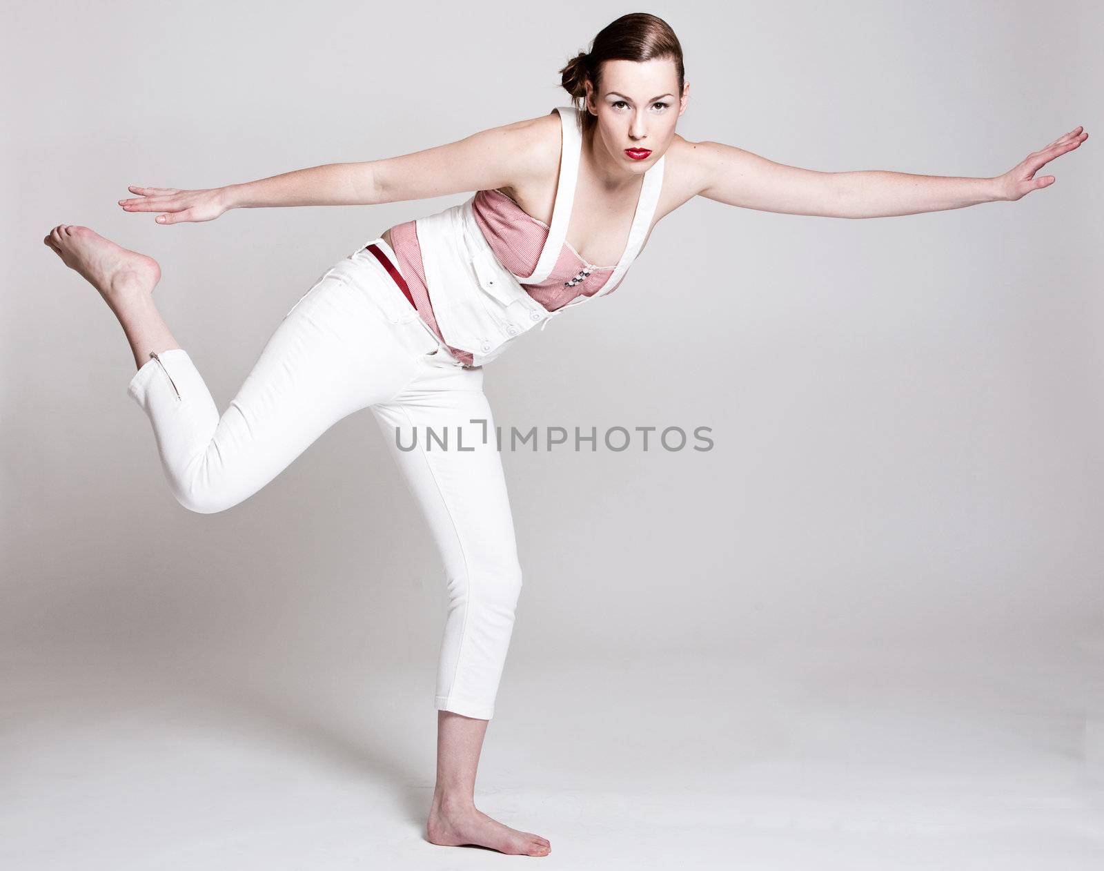Beautiful woman standing on one leg and in balance