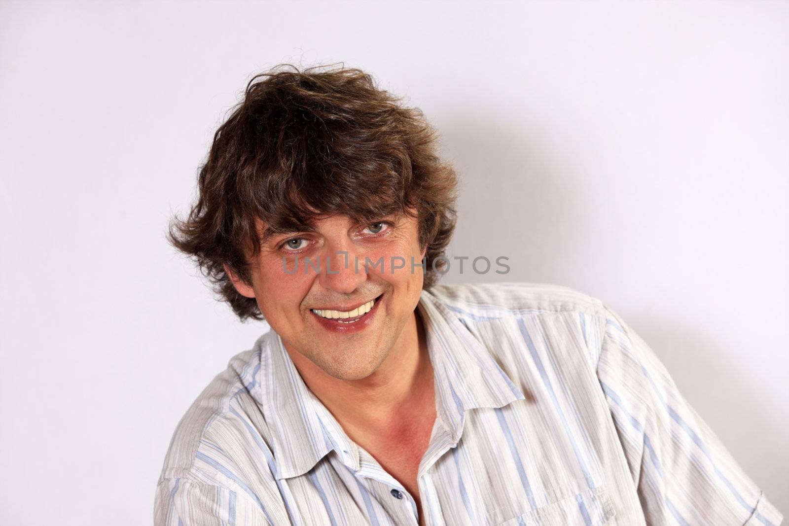 Adult man posing against white background
