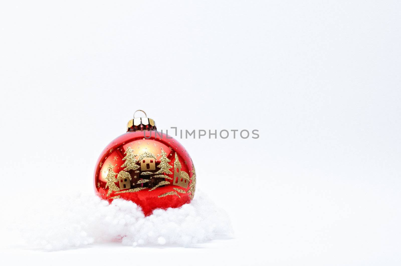 Single red Christmas Bauble with gold glitter on a white background.