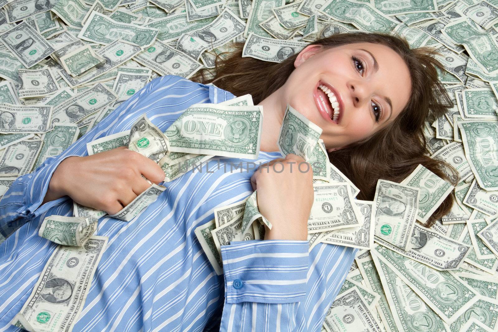 Beautiful woman laying in money