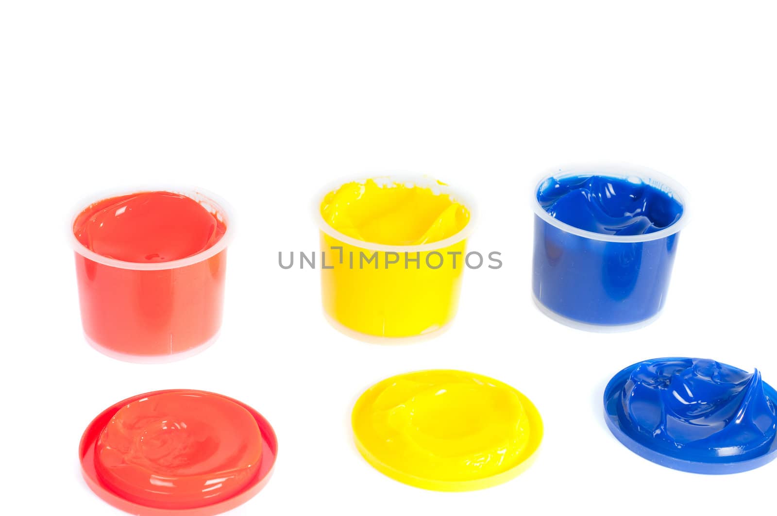 Shot of multicolored cans of paint isolated on white