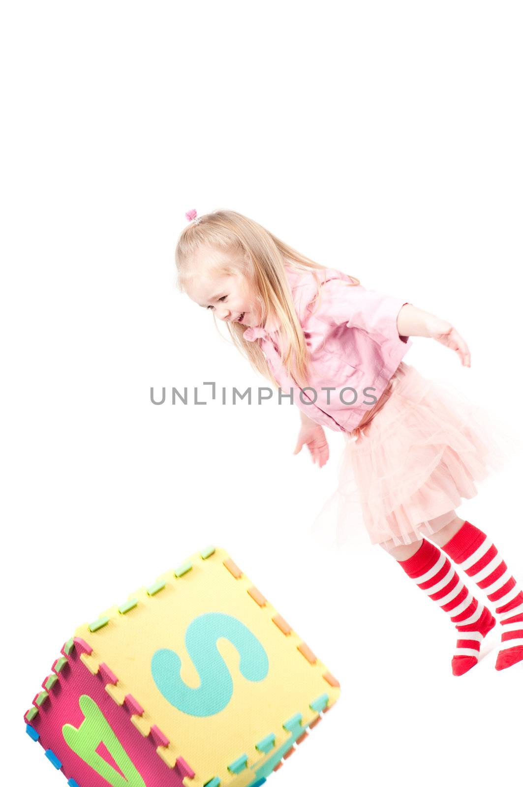 Studio shot of little girl who plaing with cube