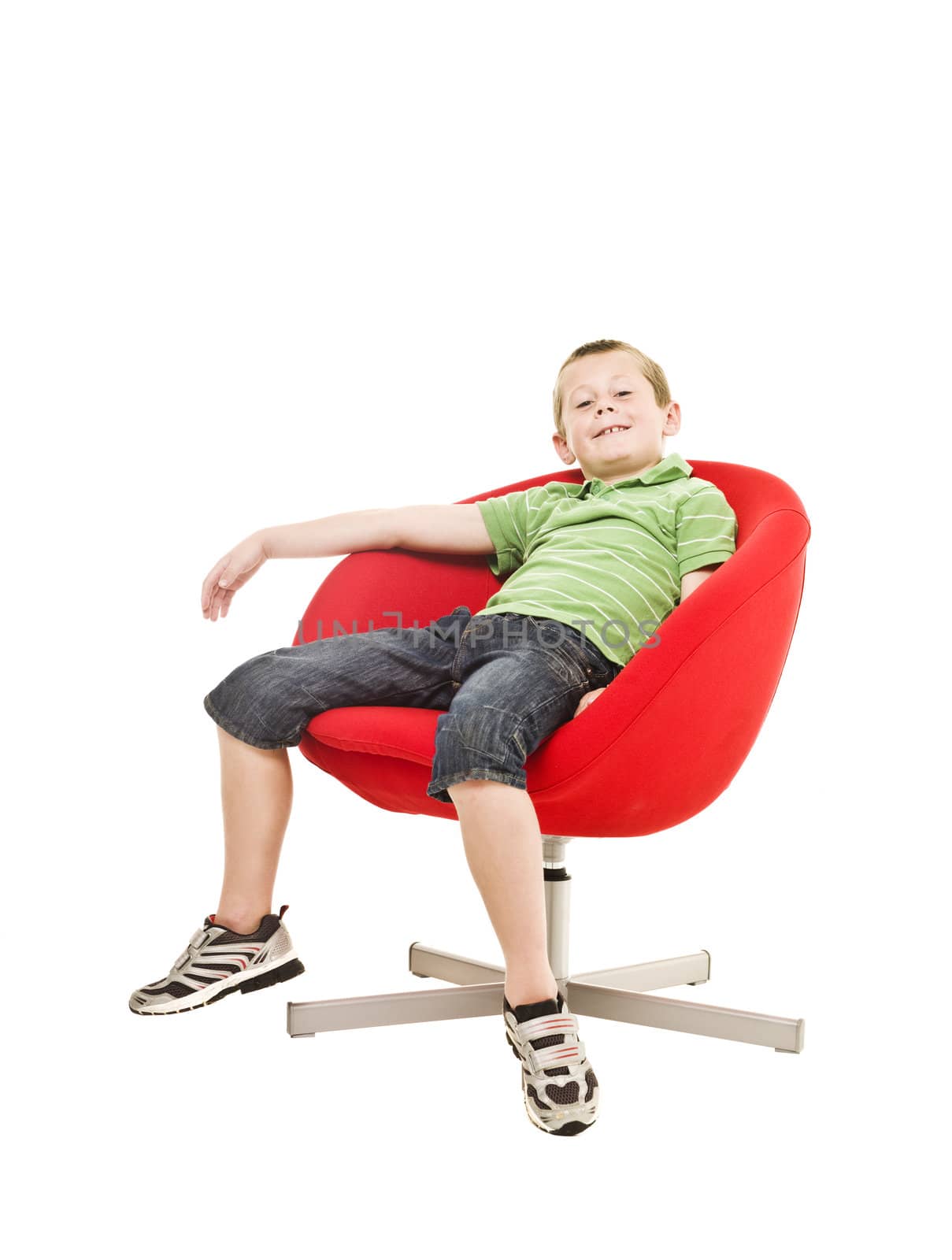 Young boy in an armchair isolated on white background