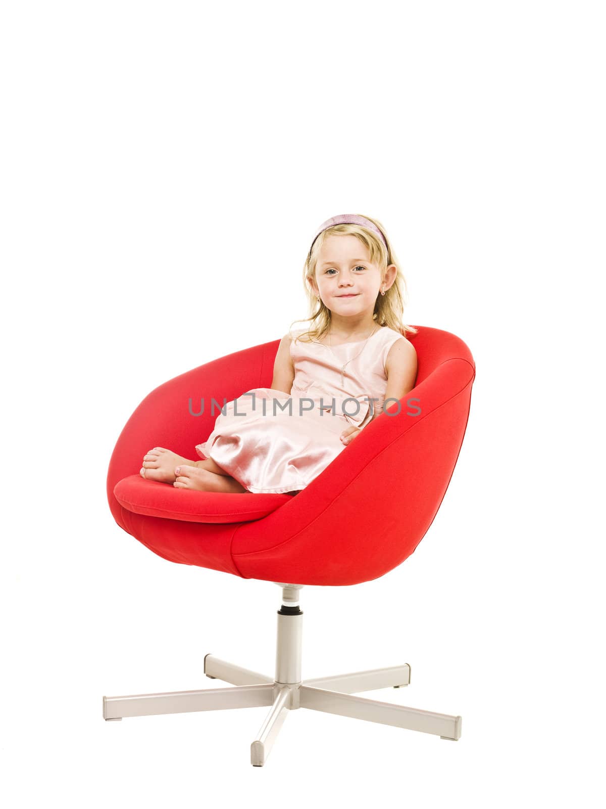Young girl in an armchair isolated on white background