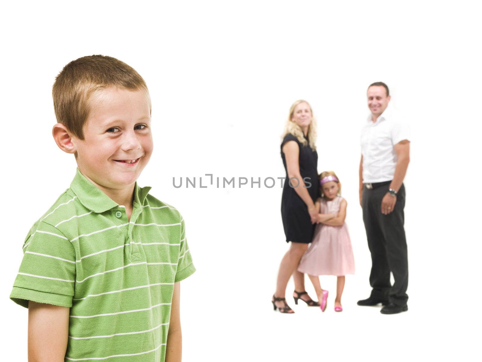 Young boy in front of his family isolated on white background