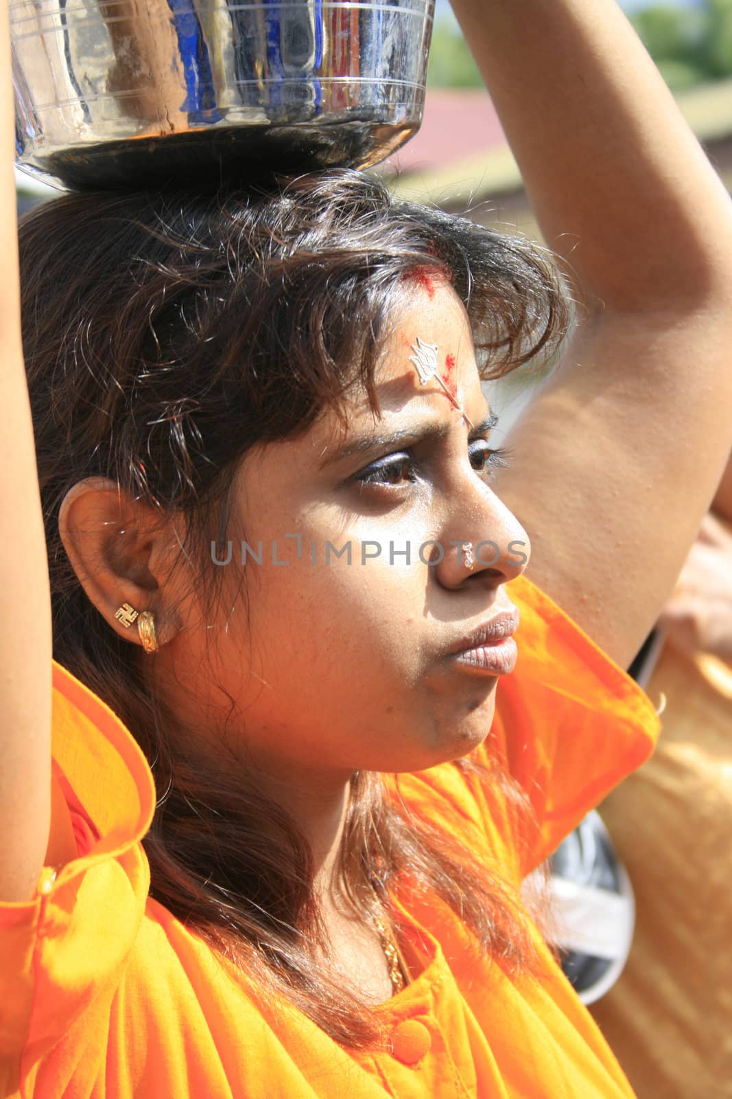 A lady offering milk in Thaipusam celebration in Singapore 2009.