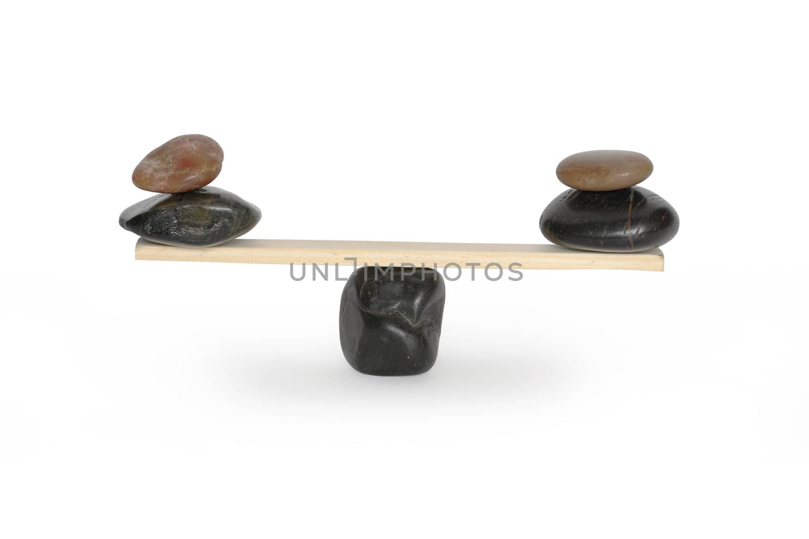 Stones lying on seesaw isolated on white background with clipping path