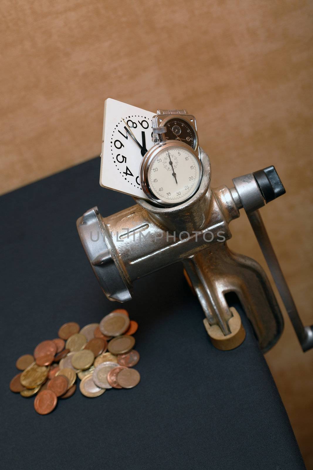 Conceptual still life with mincing machine, coins and clock