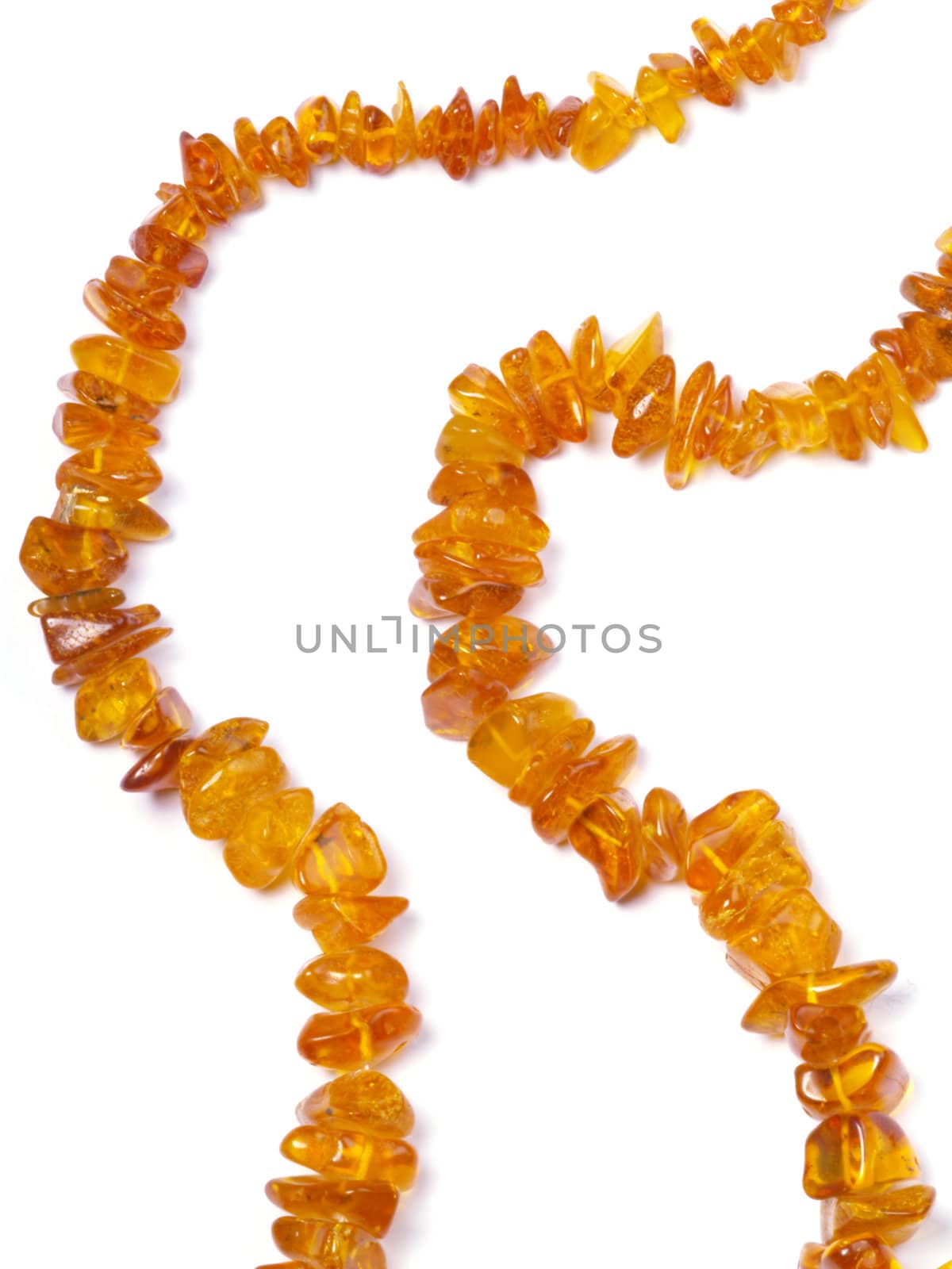 amber bead on off- white background close up