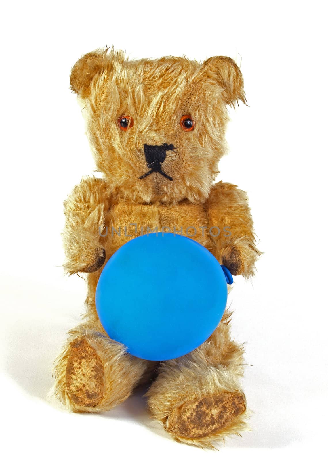 Teddy bear holding a blue balloon.