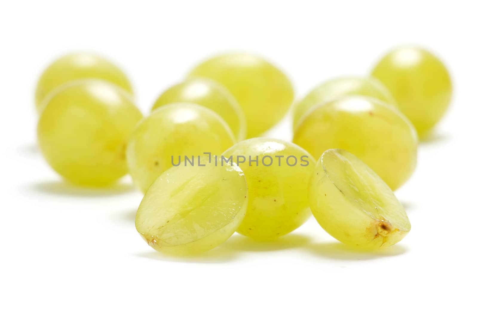 Several grape berries isolated on a white background.