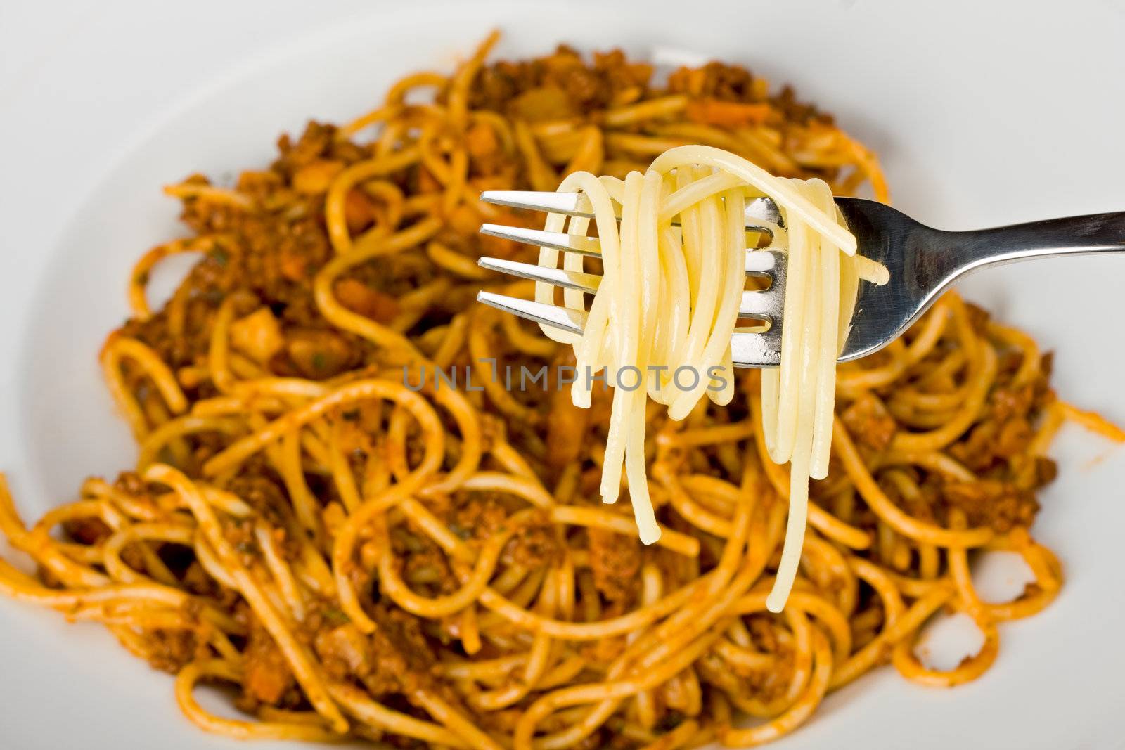 fork over a plate with spaghetti by bernjuer