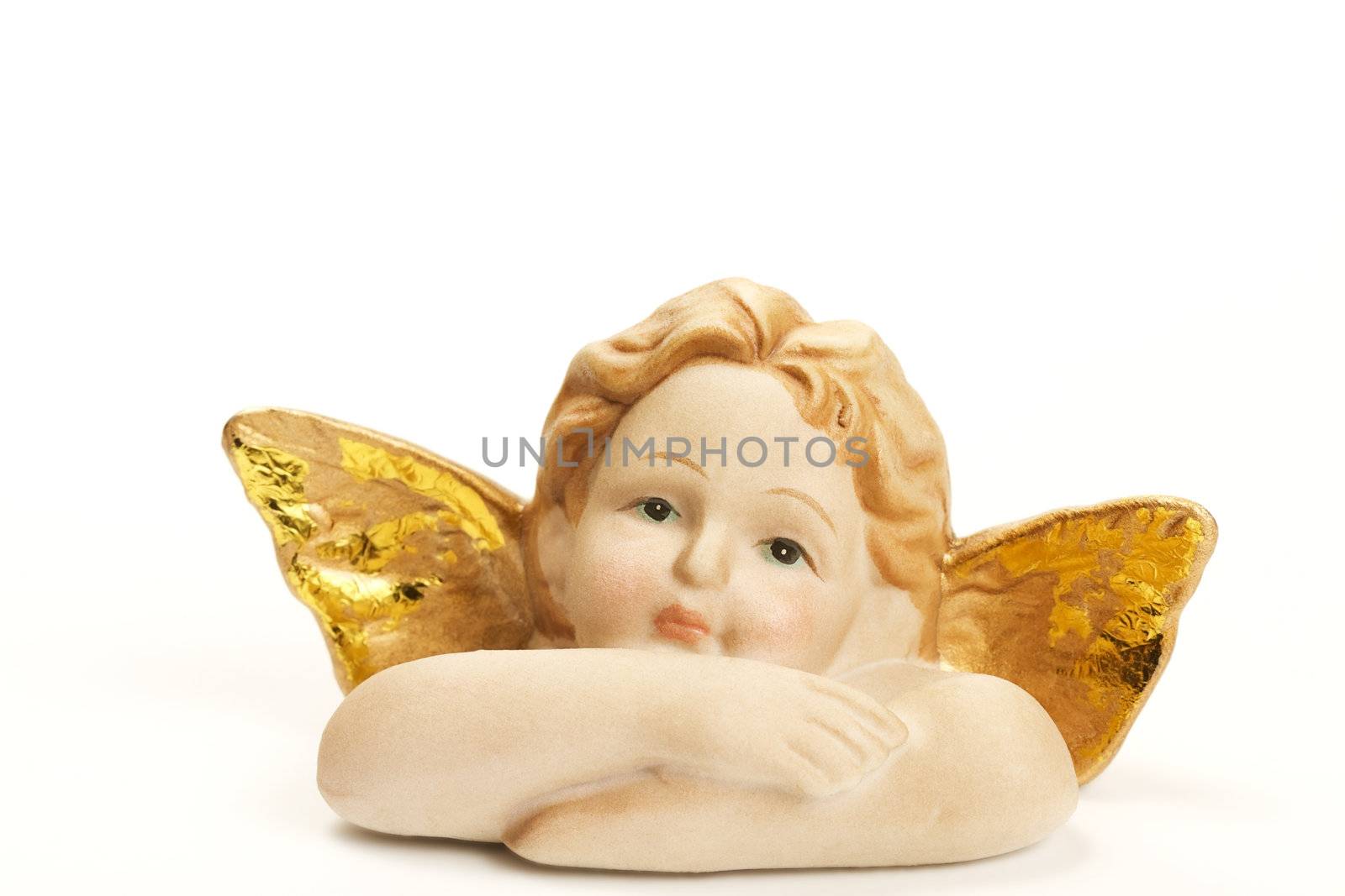 one christmas angel figurine with crossed arms on white background