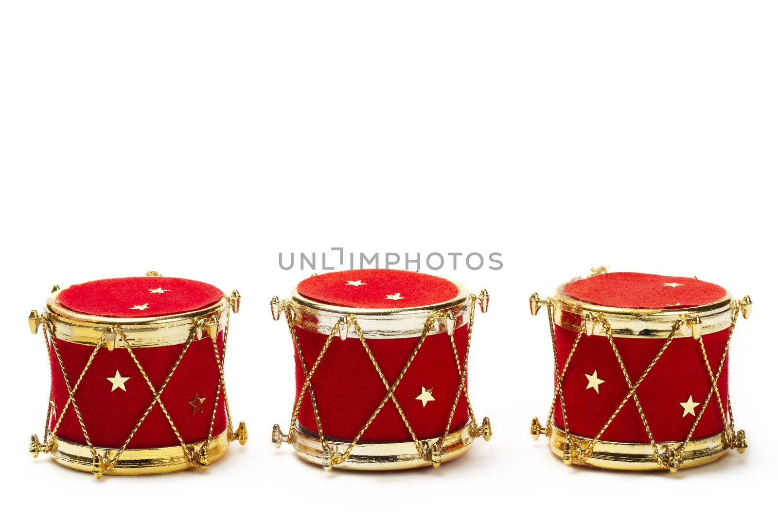 three christmas ball ornaments in drum shape on white background