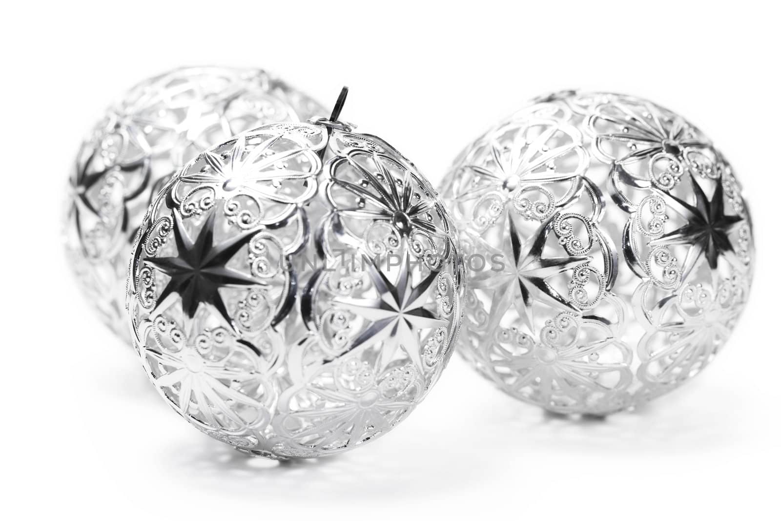 three metal christmas balls on white background