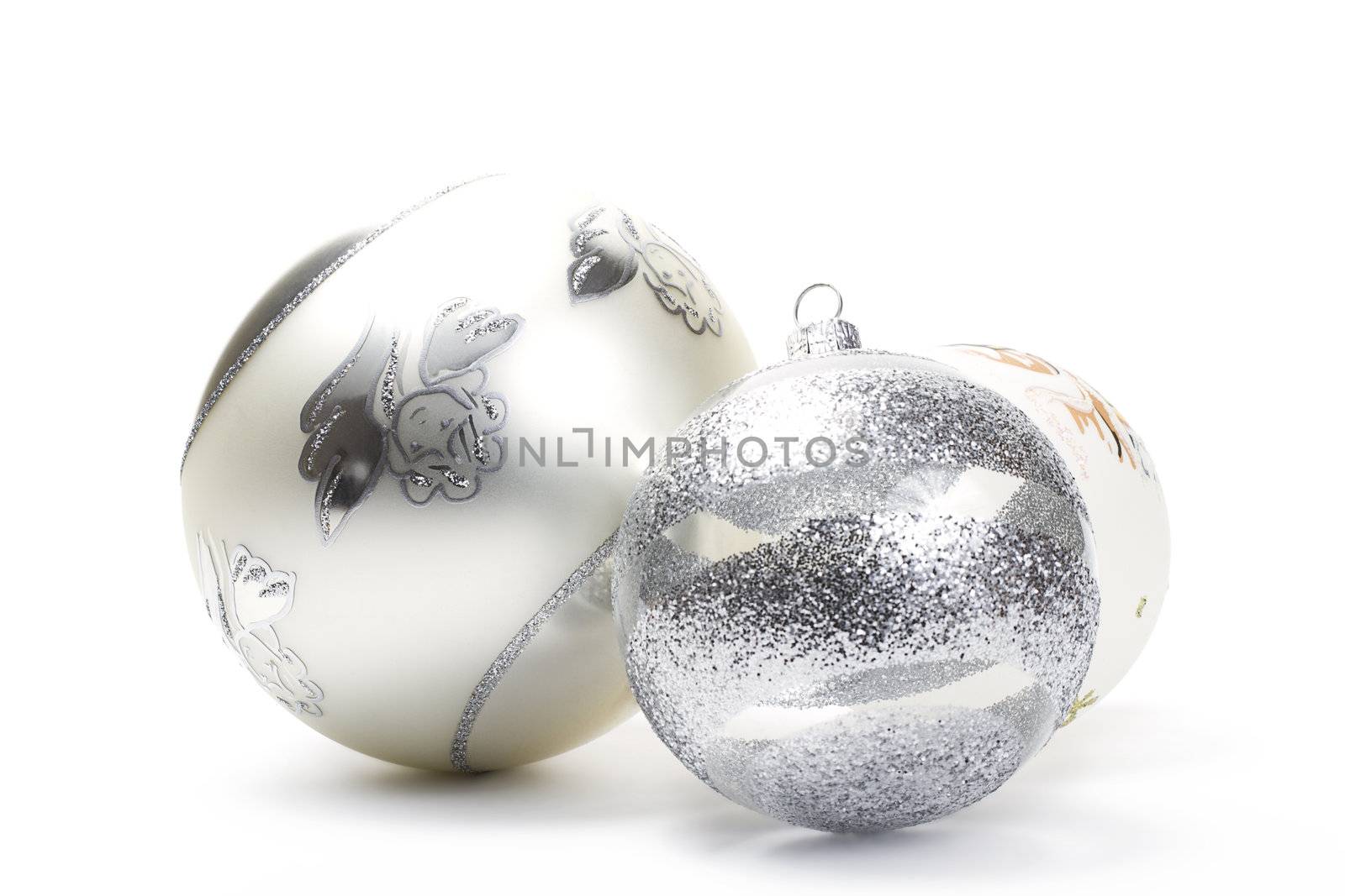 three different white and silver christmas balls on white background