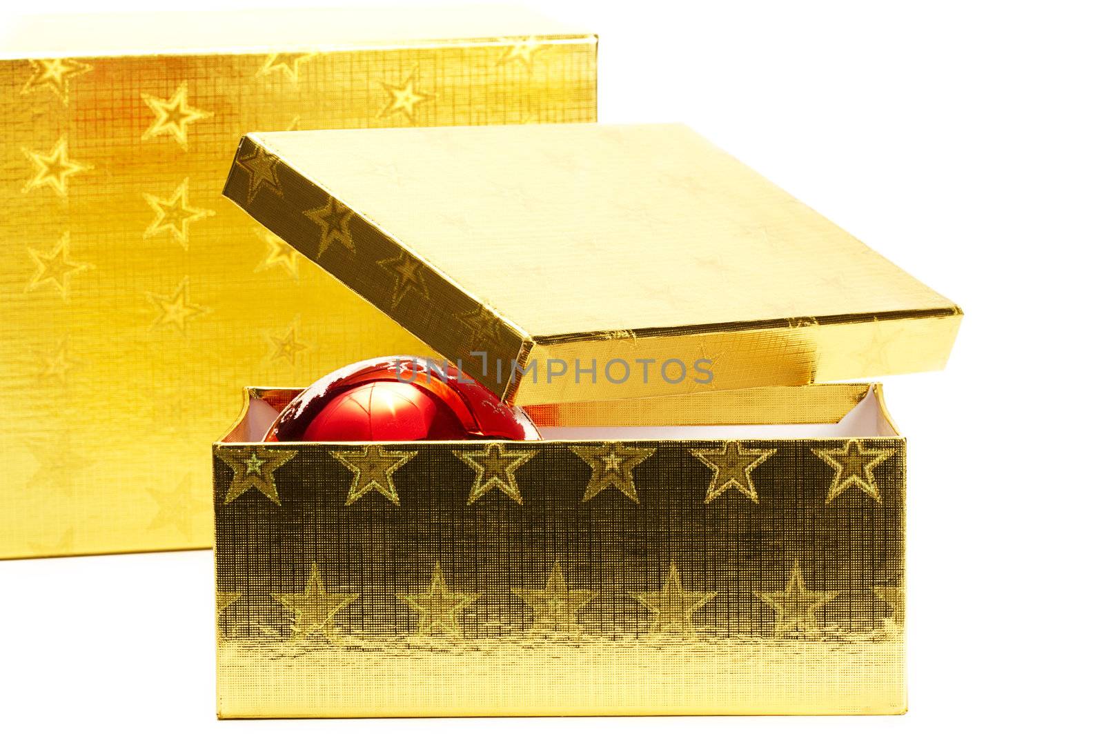two golden present boxes with one red shiny christmas ball on white background