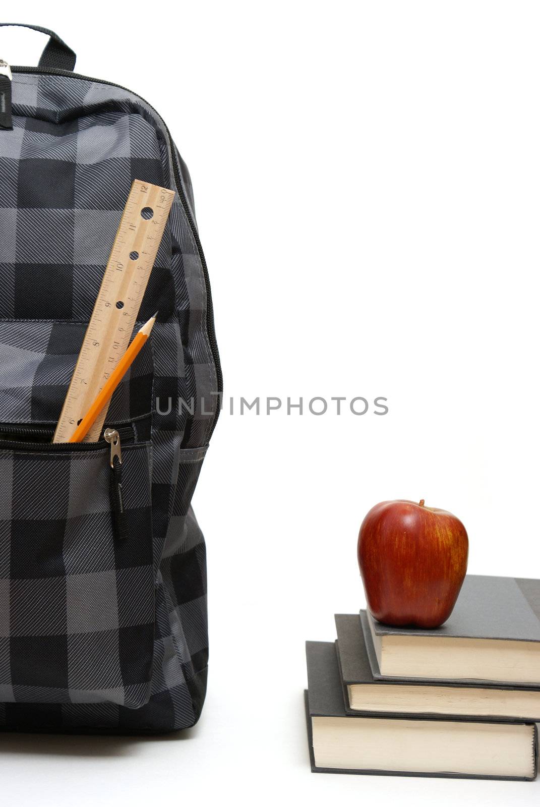 A backpack and some educational books isolated on white.