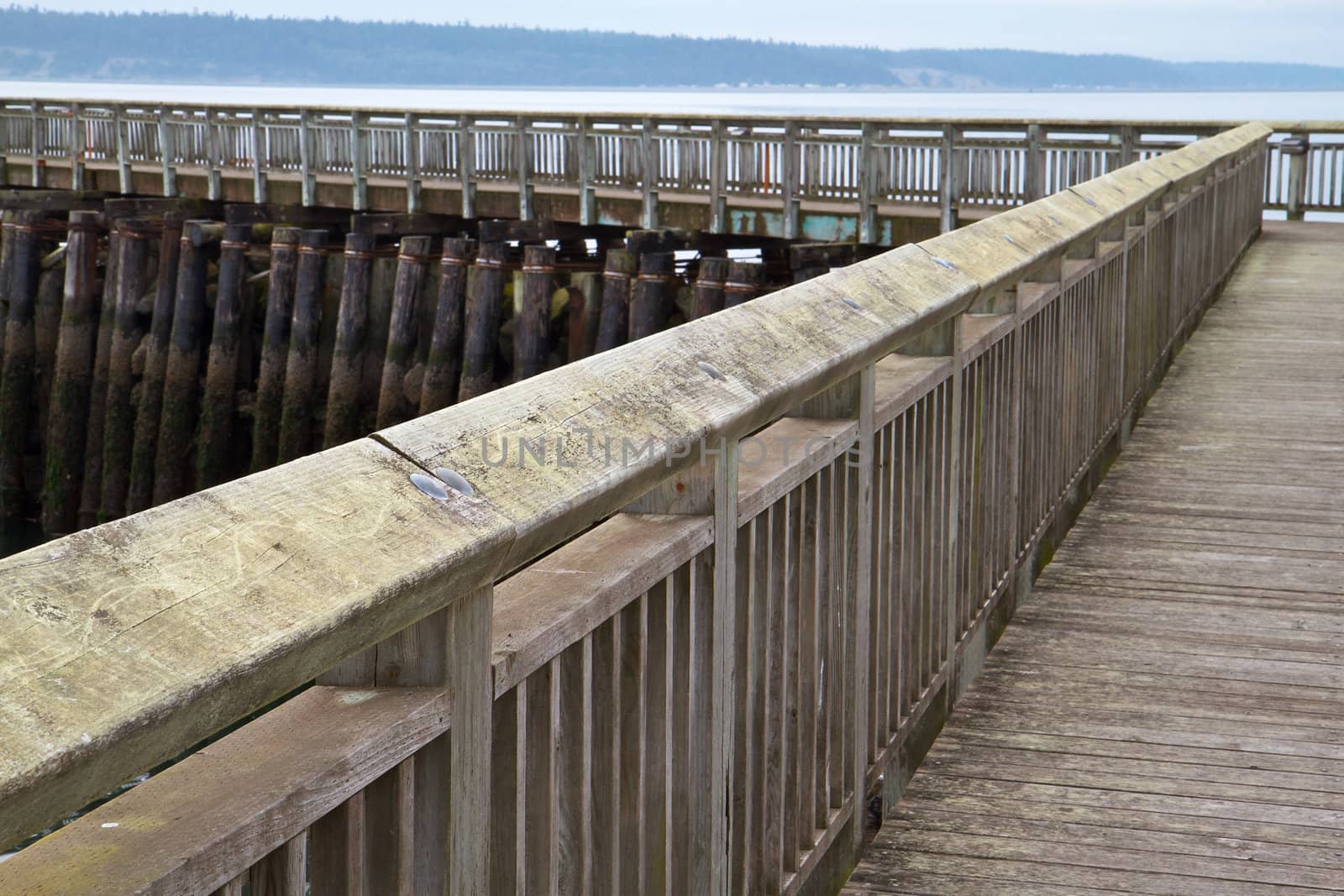  Angled Pier Boardwalk with soft focus background of overcast bay