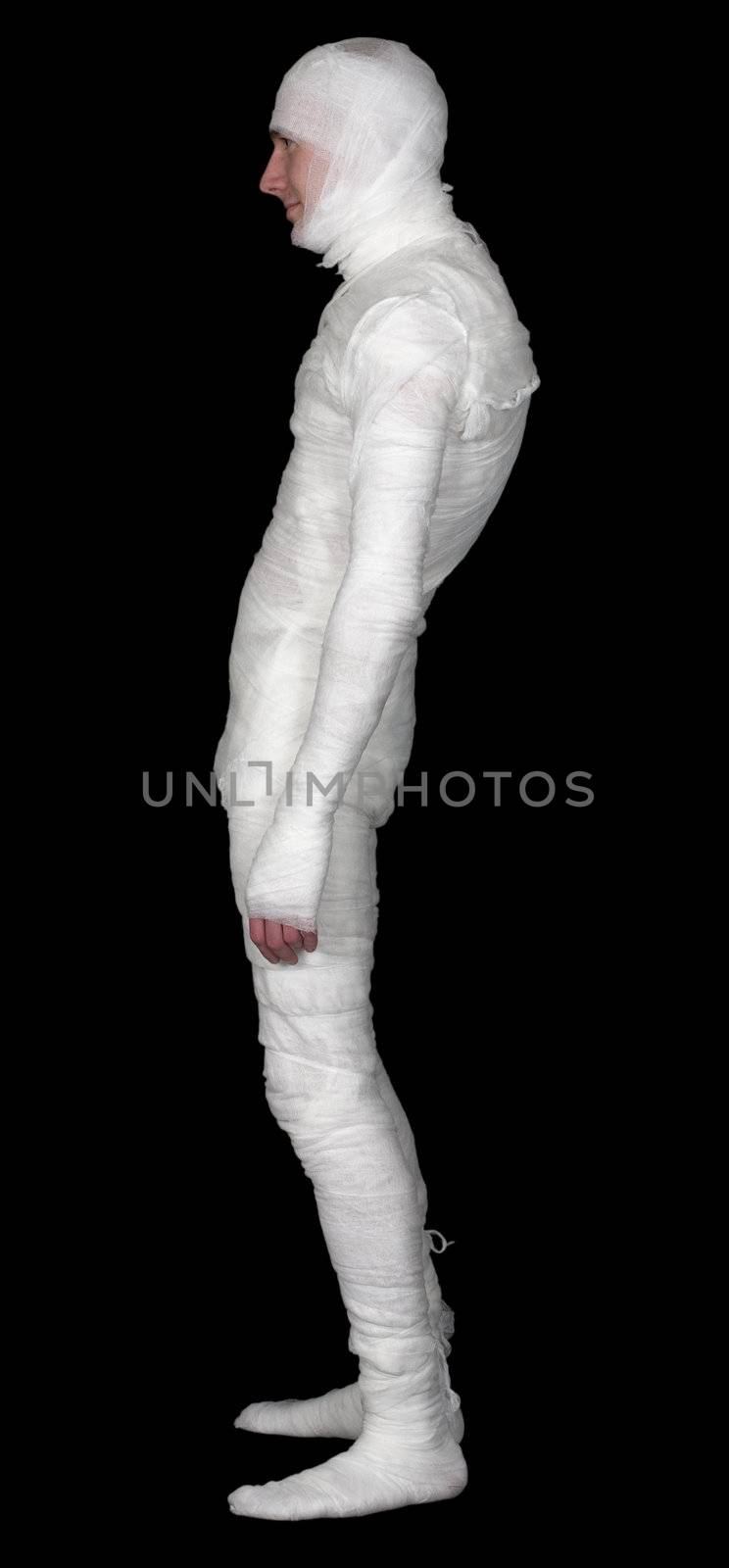 The guy in bandage upright on a black background