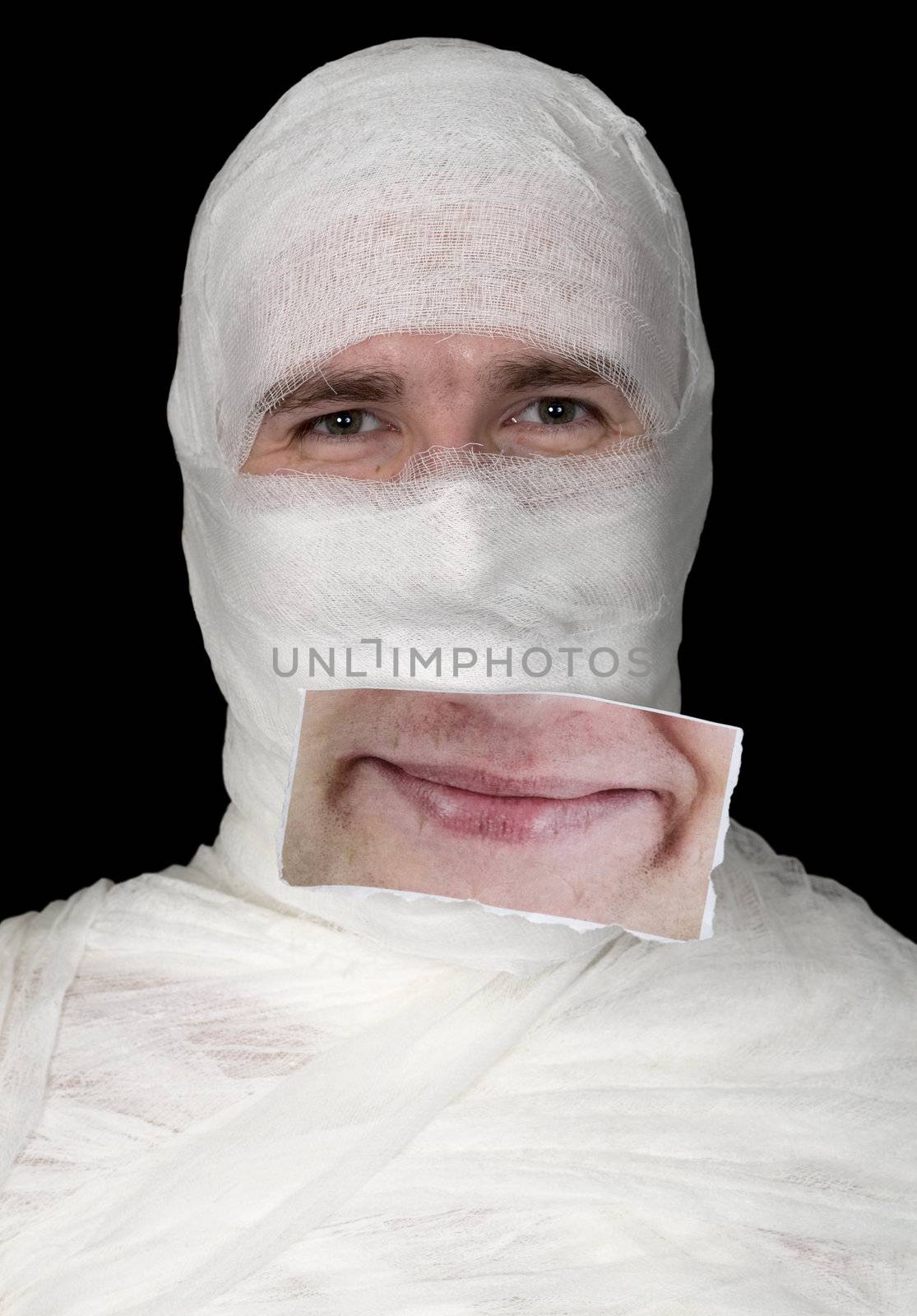 Head of the guy rolled up by bandage with a false smile