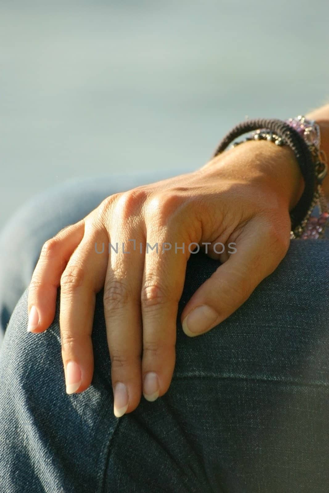 Beautiful hand resting on the knee