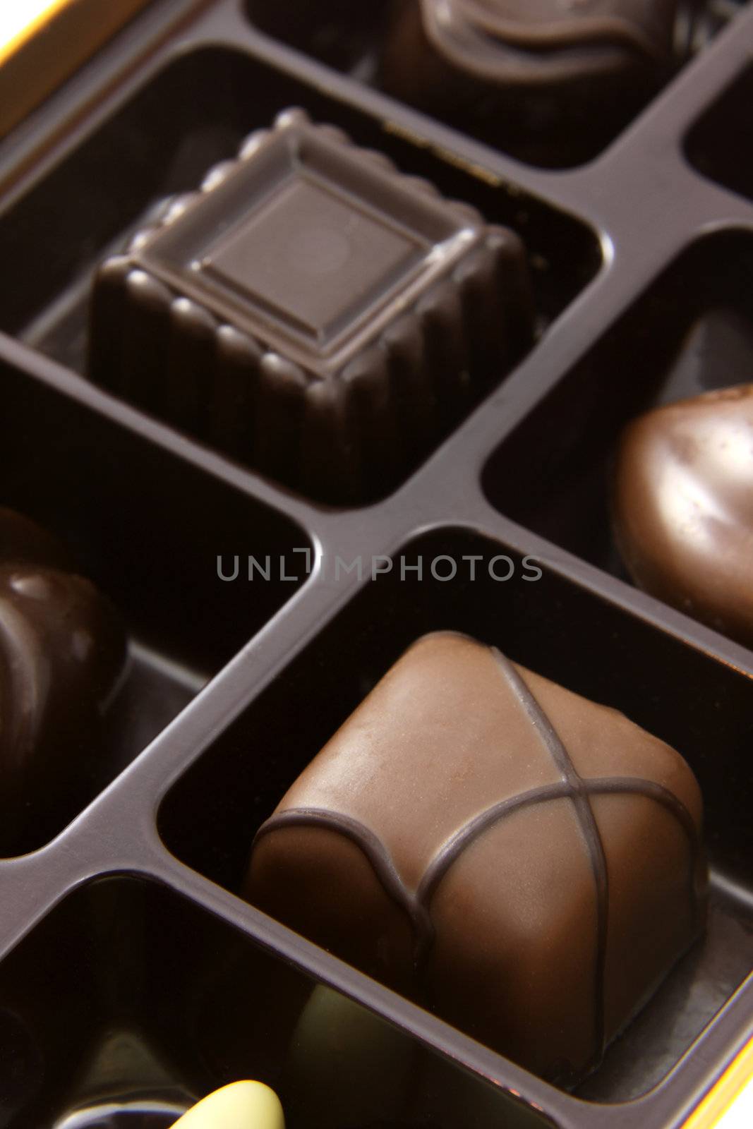 A closeup of a box of chocolate truffles.
