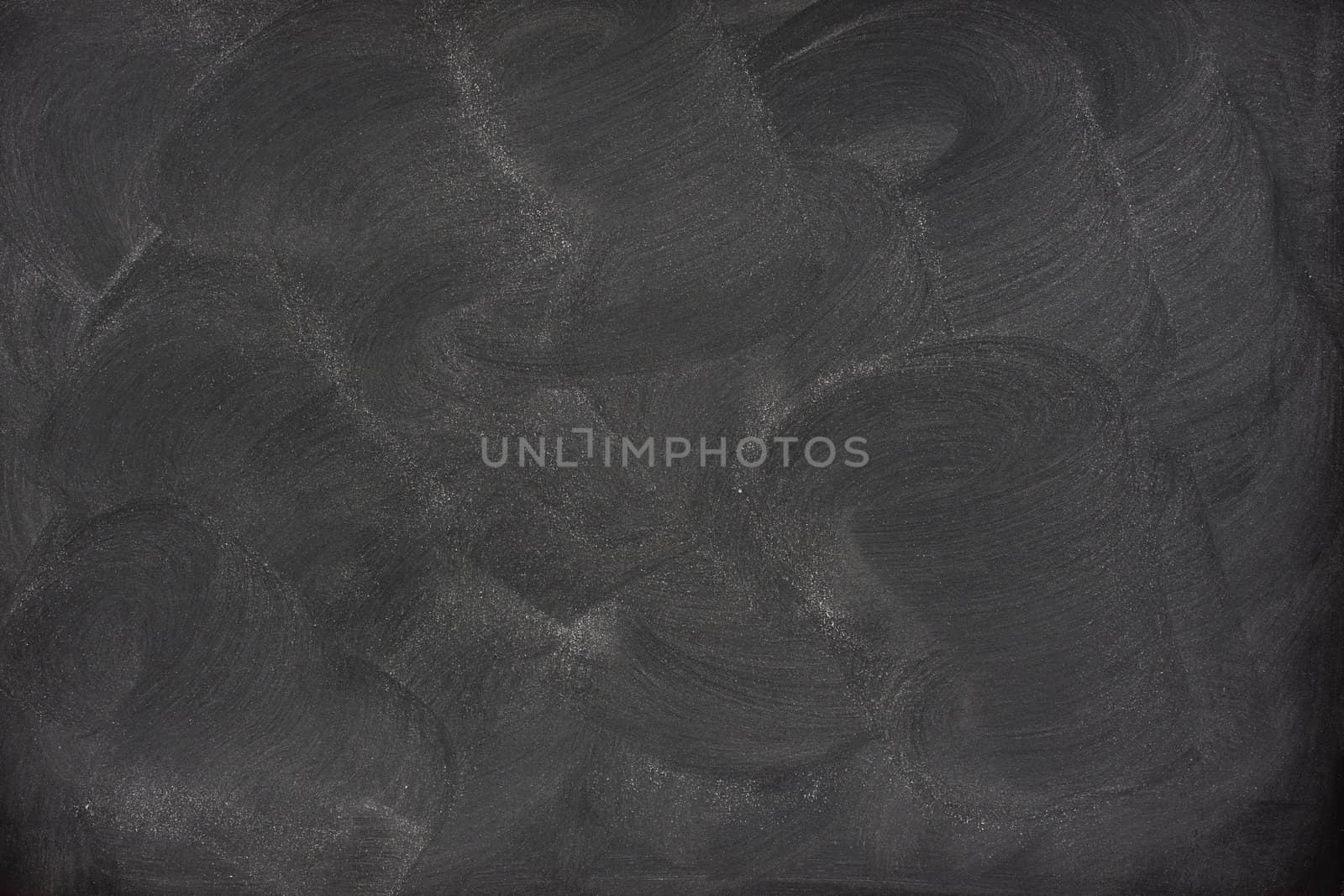 blank blackboard with eraser smudges by PixelsAway