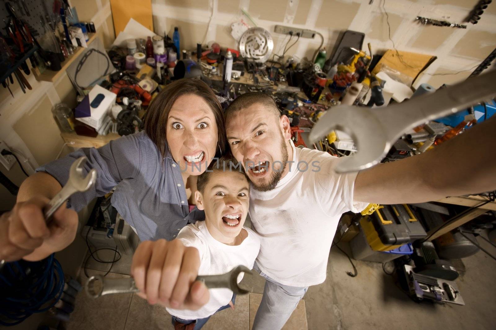 Crazy Hispanic family in garage with crescent wrenches