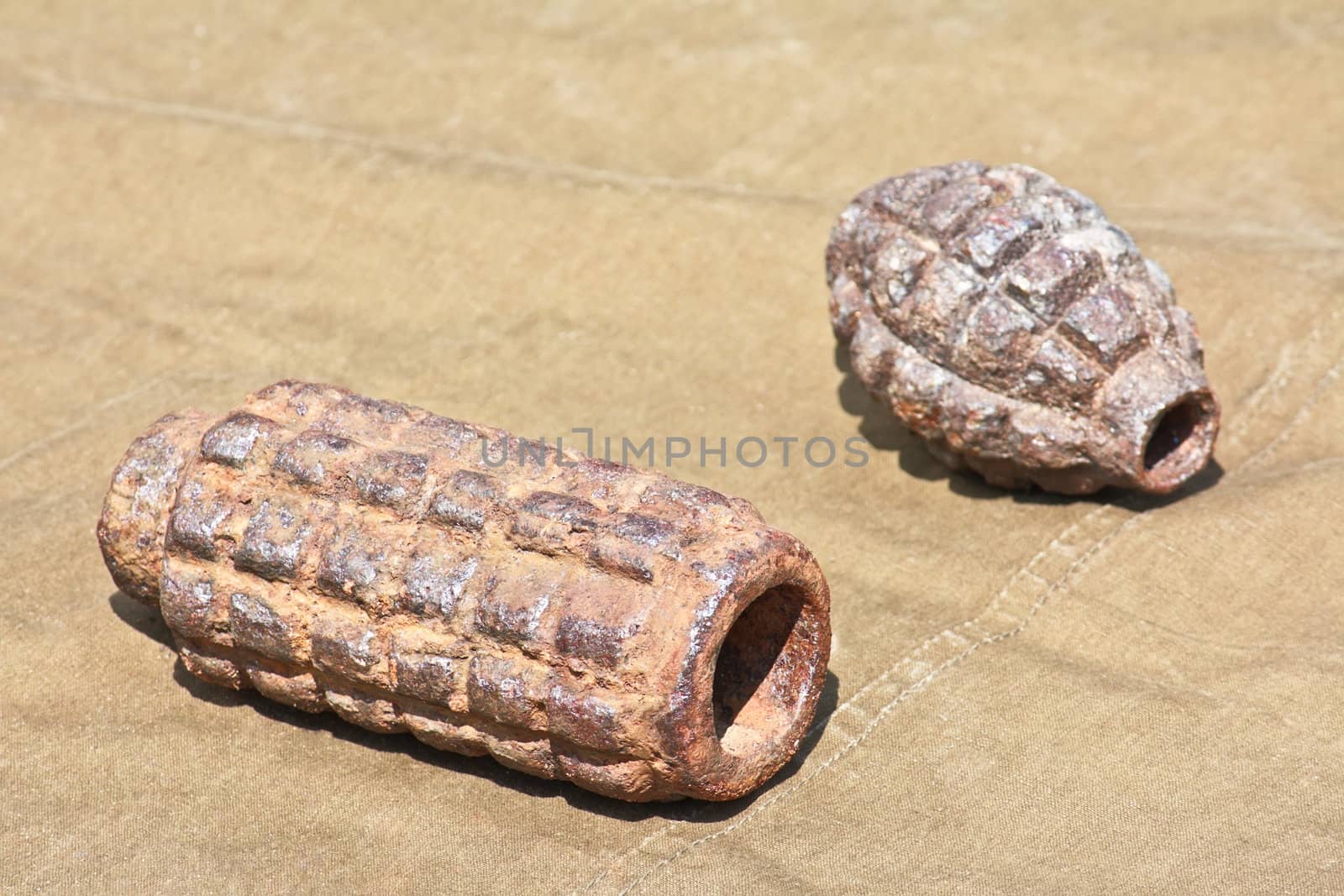 Old defused World War II high-explosive shells lying on the tarpaulin
