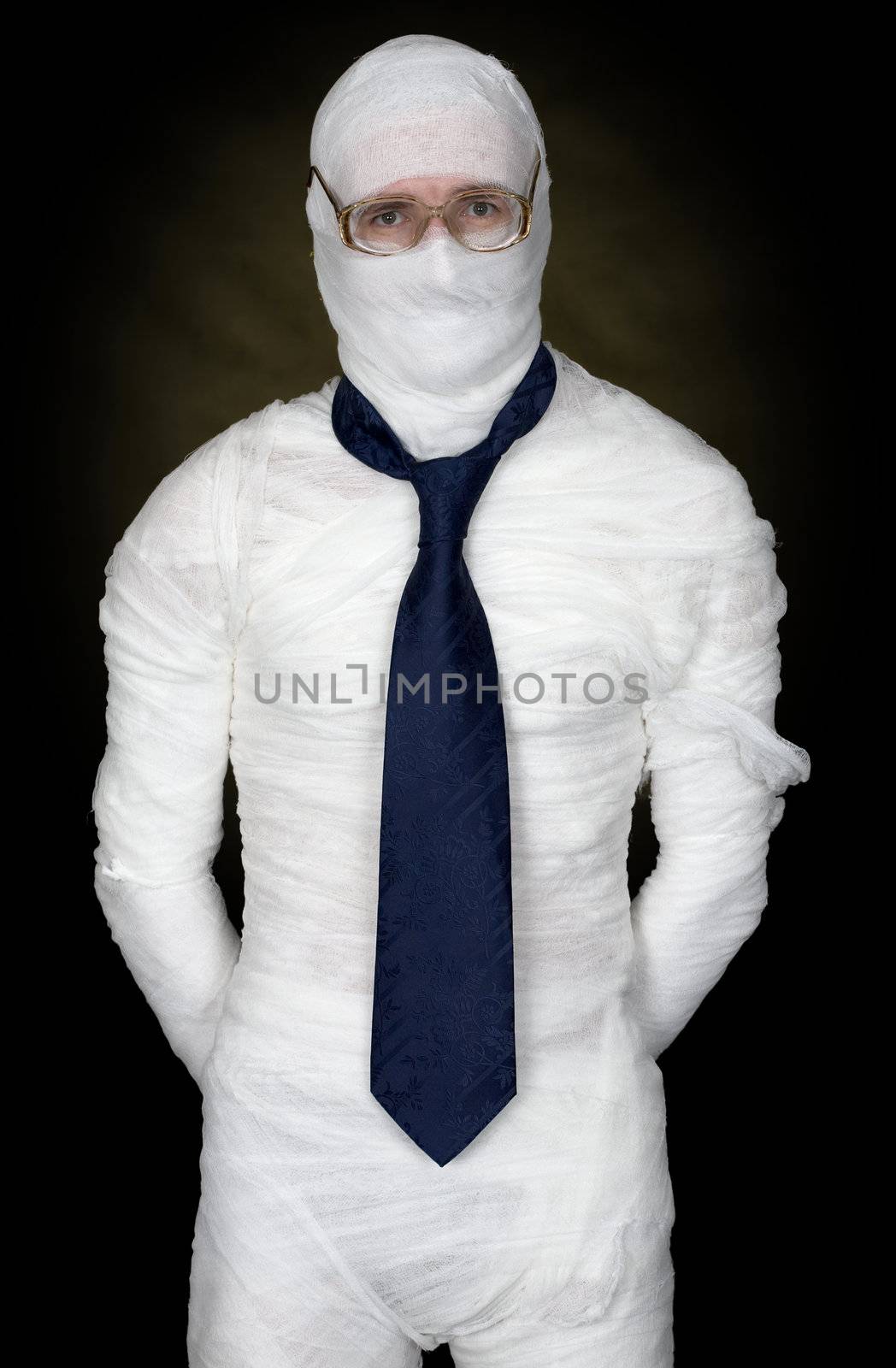 Man in bandage with eyeglasses and  the cravat on black