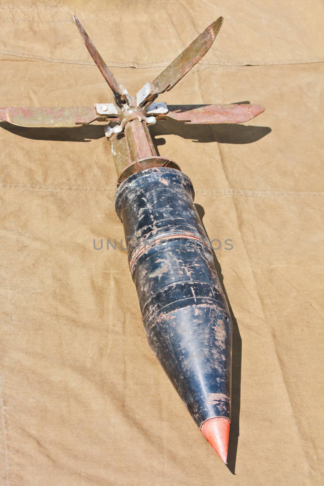 Defused mortar shell lying on the tarpaulin