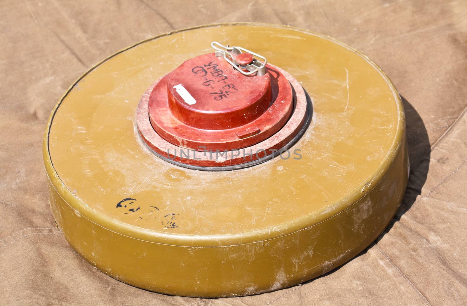 Defused antipersonnel mine lying on the tarpaulin