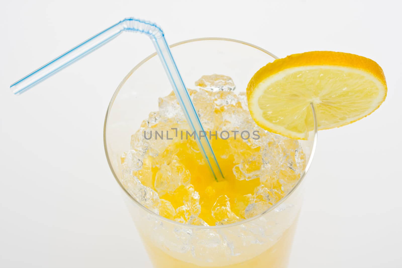 glass of orange juice with lemon slice and straw