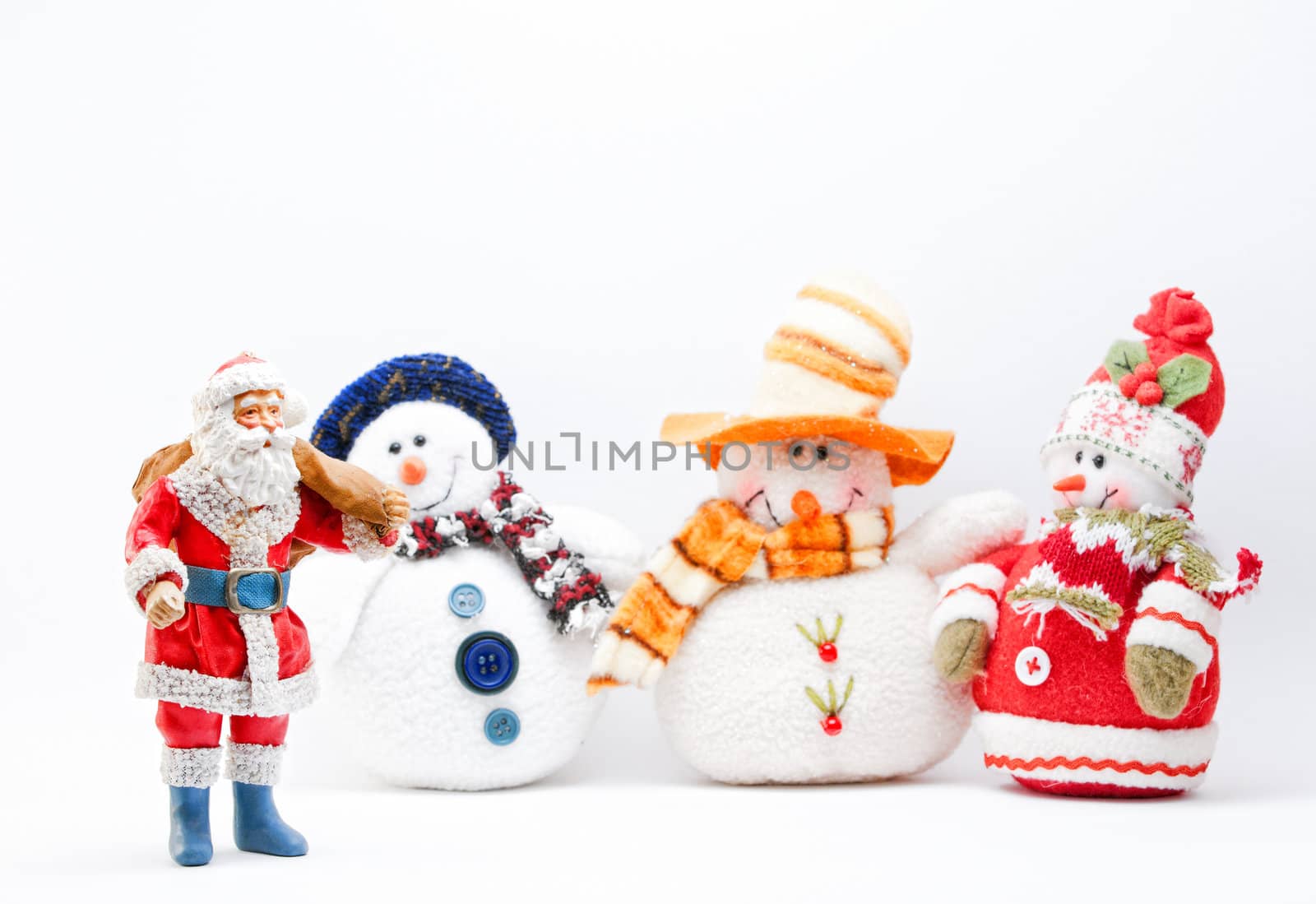 Father Christmas and three Snowmen on a white background (Selective Focus)