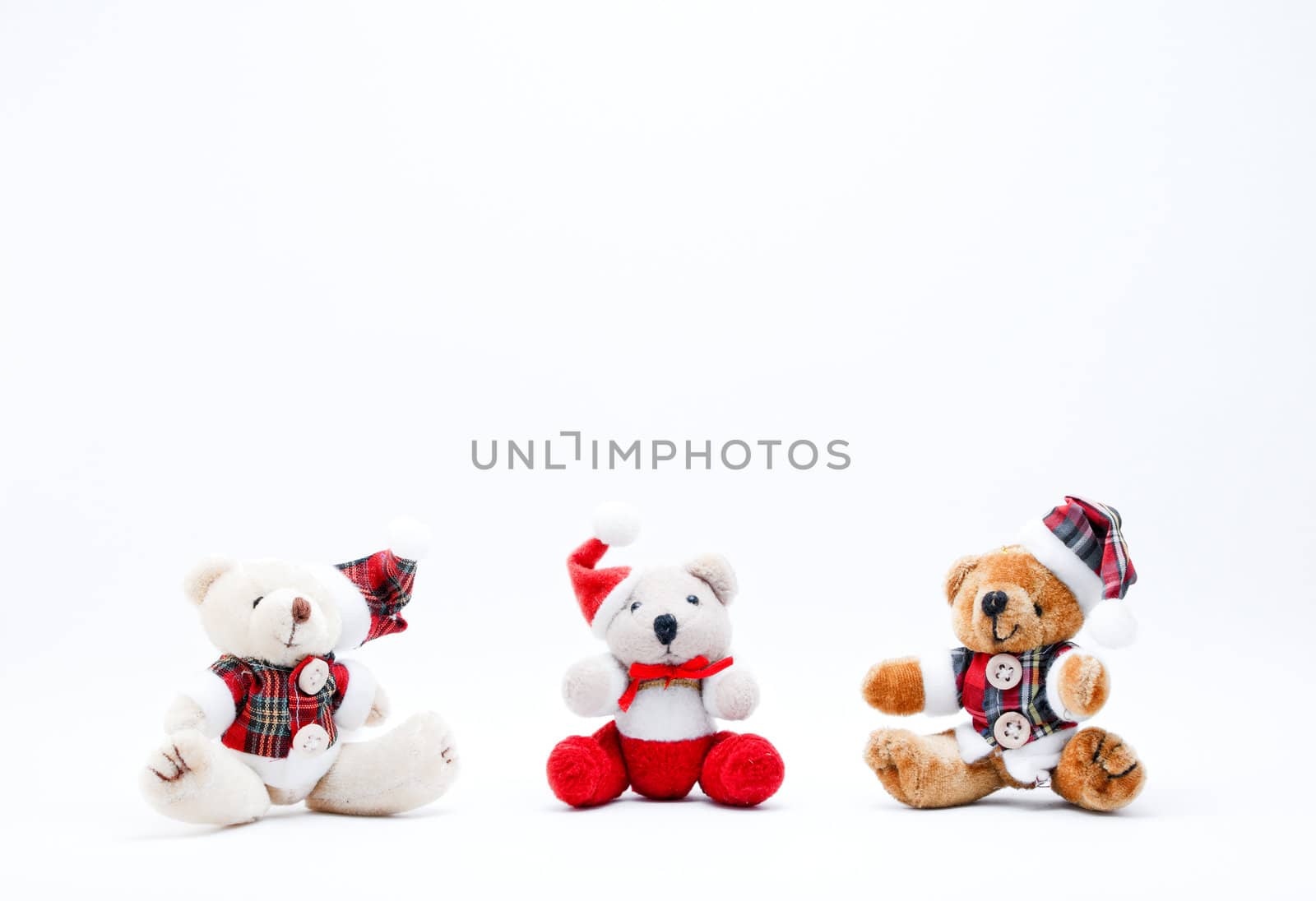 Three Christmas Cuddly Toys on a White Background.
