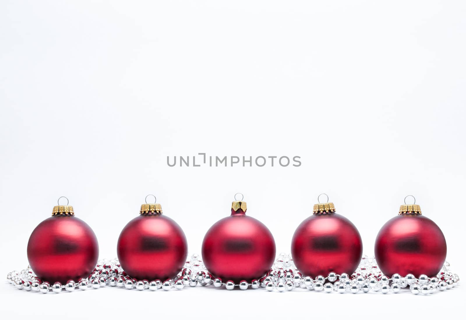 Christmas Baubles with Silver Beads on a White Background.