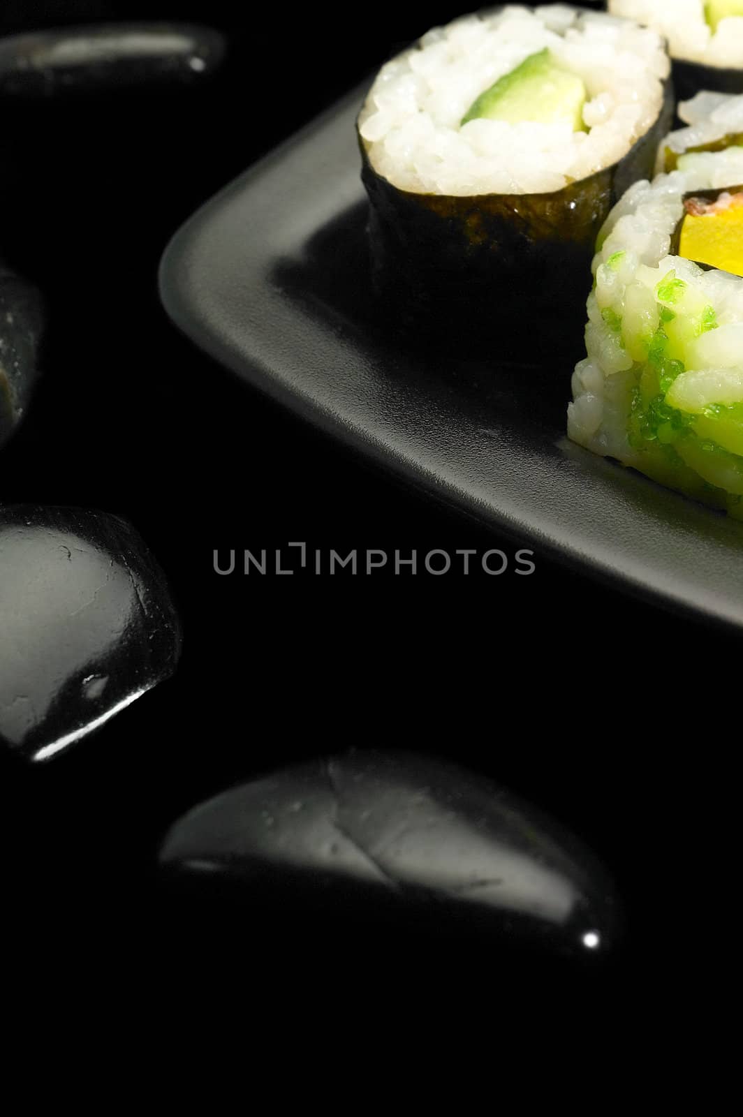 fresh colorfull assorted sushi plate over black