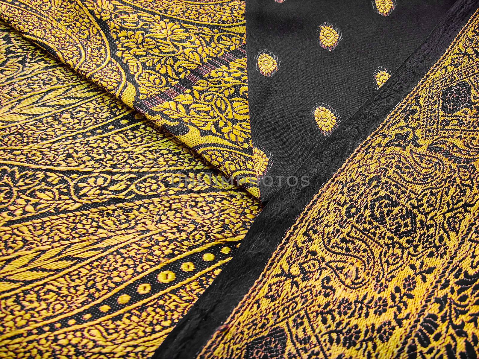 Black and yellow traditional indian outfit known as a saree/sari