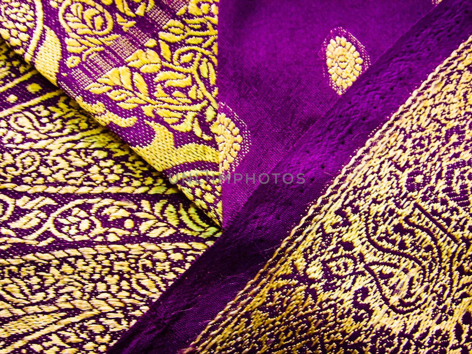 purple and yellow traditional indian outfit known as a saree/sari