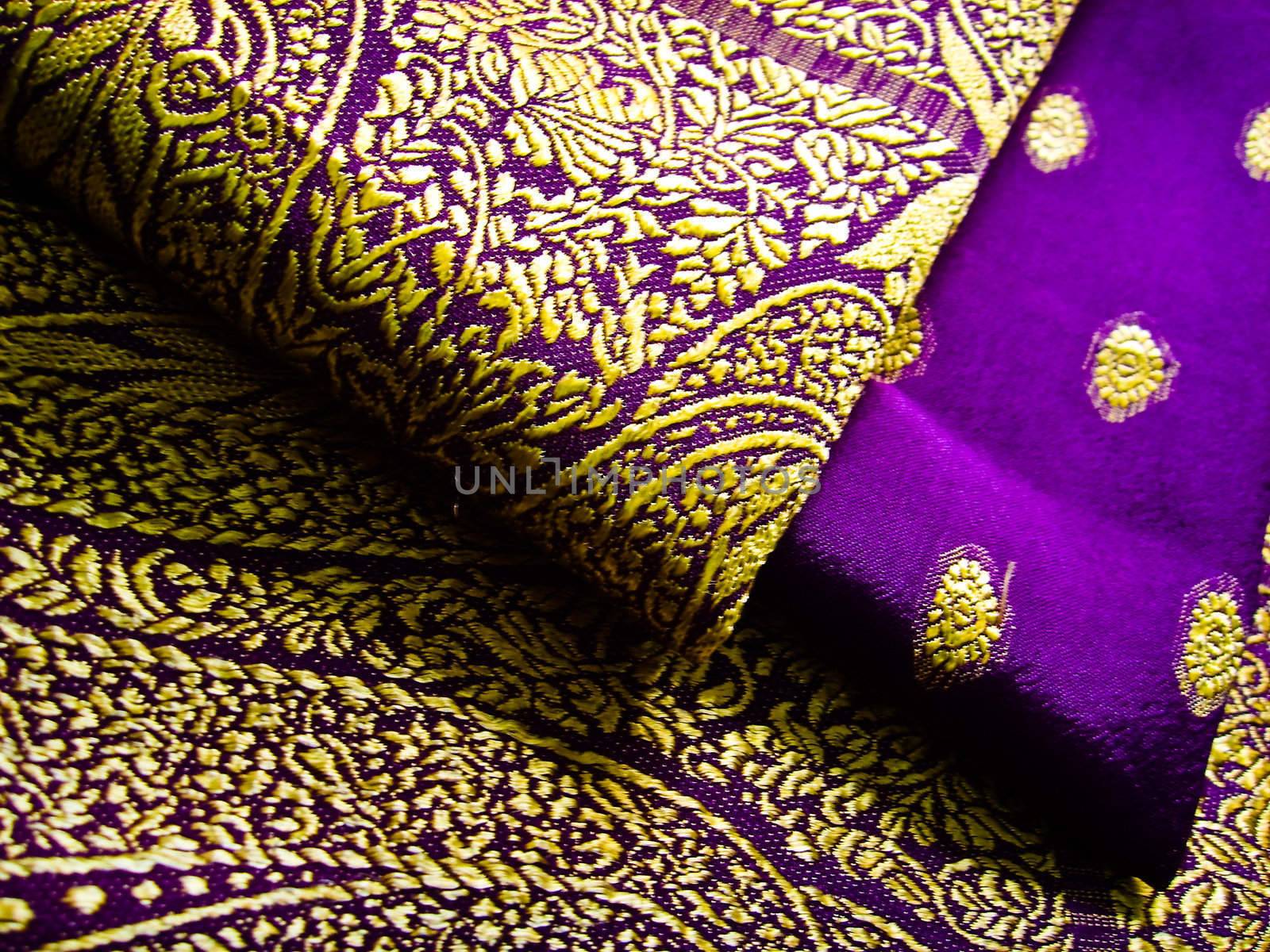 A purple and yellow saree folded