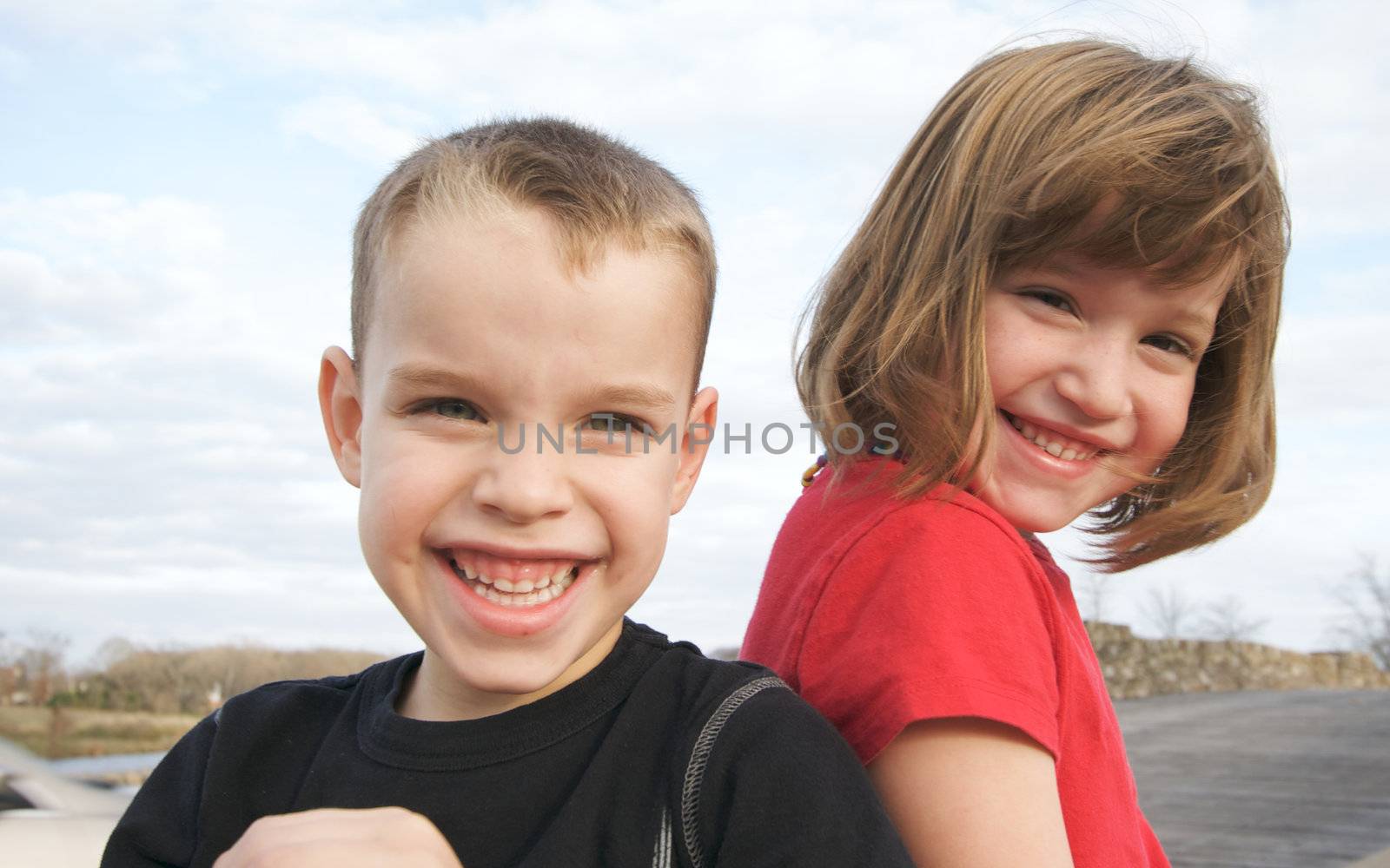 Two Children Smile for the Camera by Feverpitched